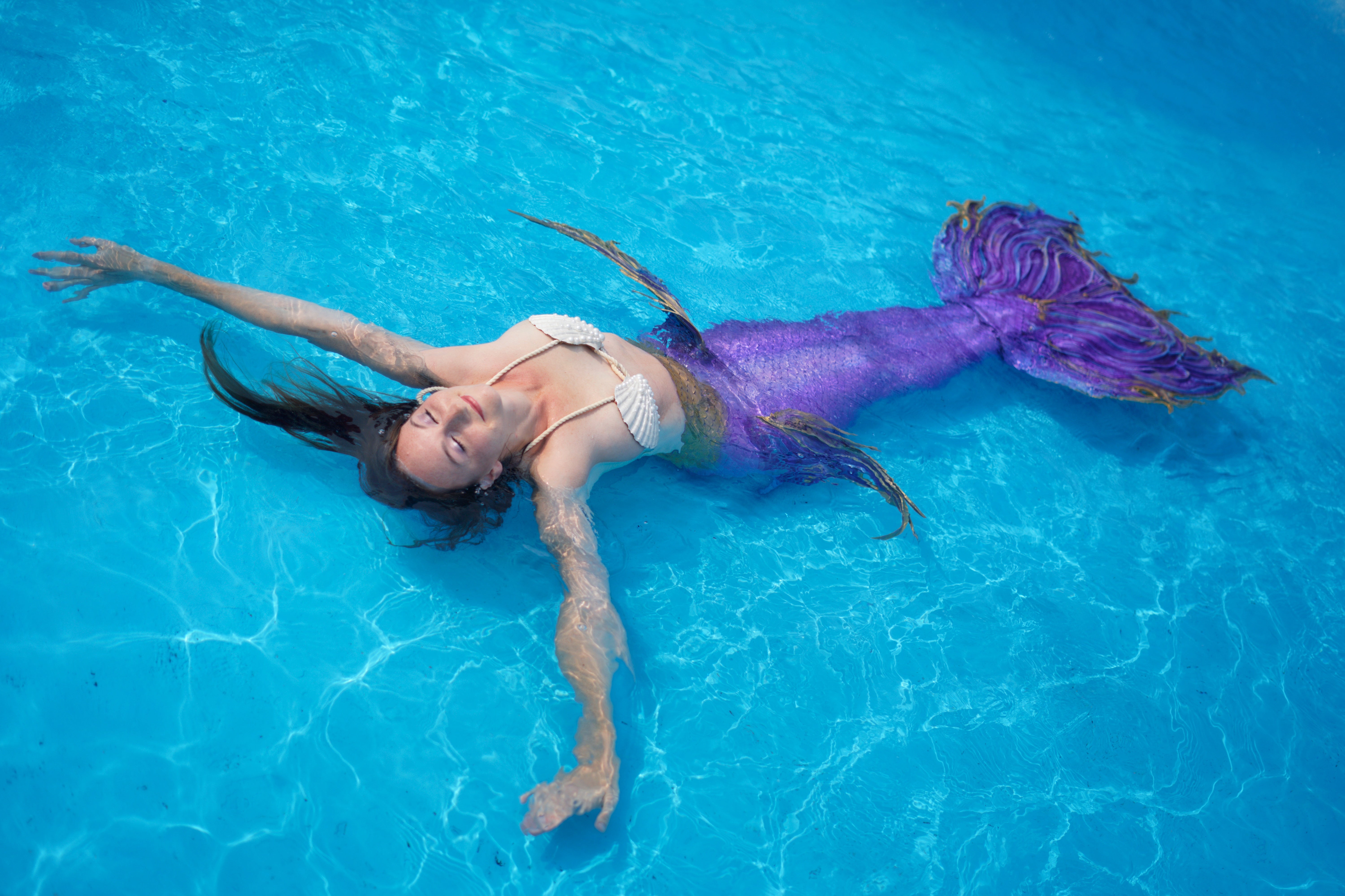 Mermaid performer floating in pool in Halifax